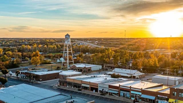 Aerial view of downtown Blanchard, Oklahoma, with the water tower and Main Street at sunset