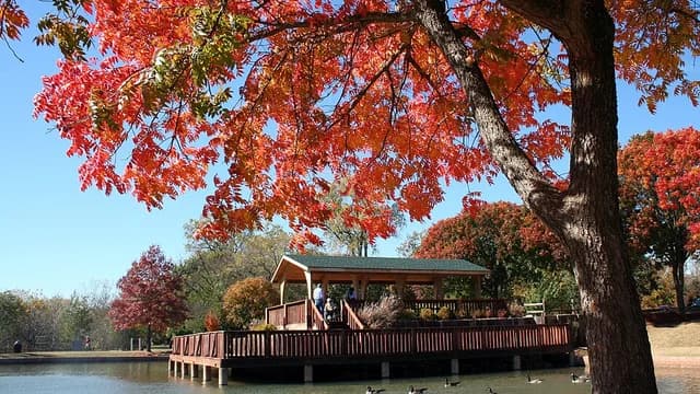 Autumn trees and a lakeside pavilion at Hafer Park in Edmond, Oklahoma