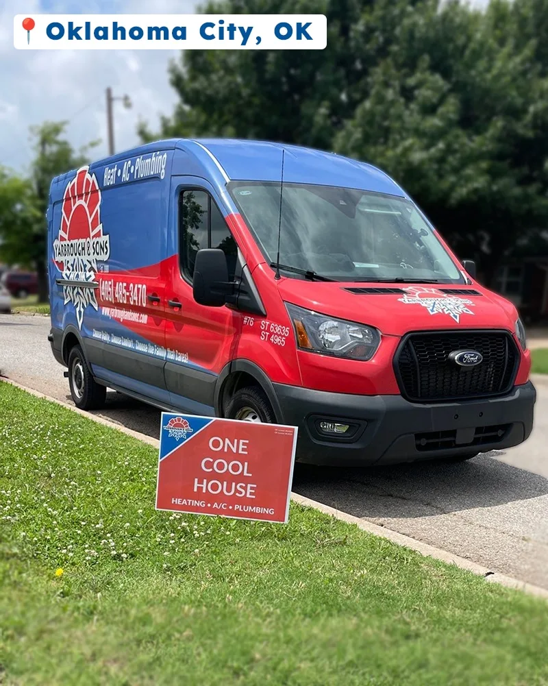 A Yarbrough & Sons service van parked in a residential area of Oklahoma City with a bright red “One Cool House” yard sign displayed on the lawn, promoting HVAC service.