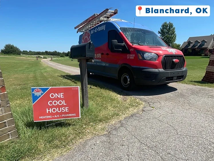 Yarbrough & Sons service van parked in a long driveway in Blanchard, OK, with a “One Cool House” yard sign positioned near the mailbox.