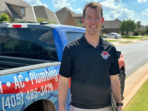 Will Yarbrough stands outside his vehicle in OKC during an HVAC inspection.
