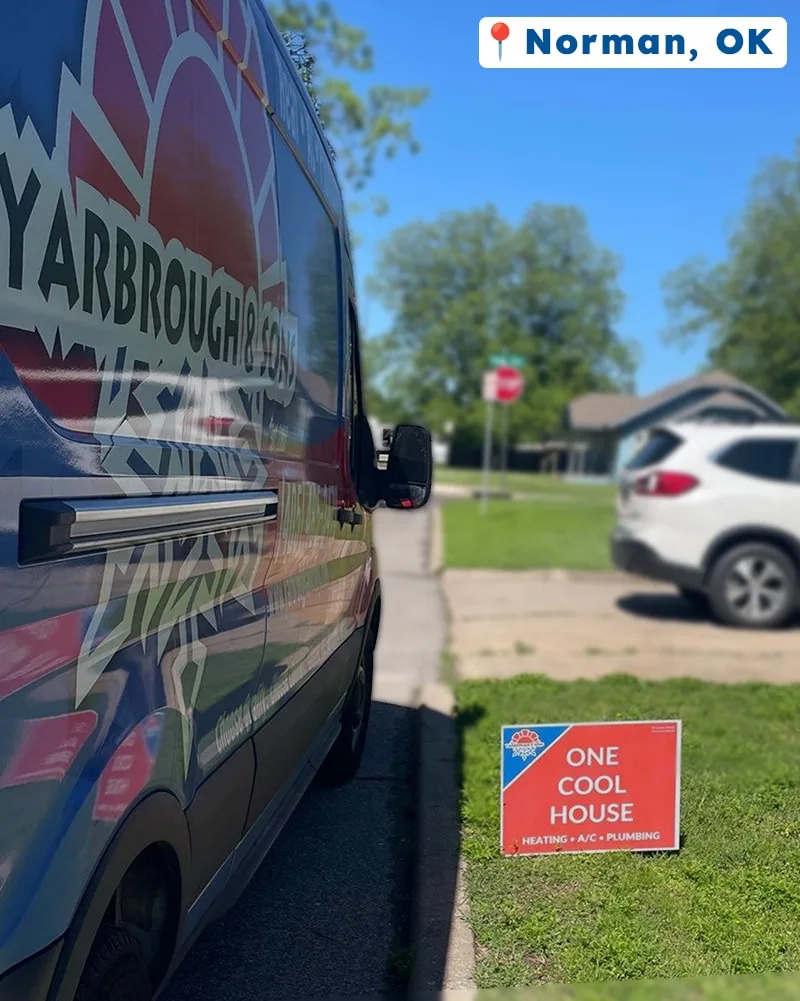 A Yarbrough & Sons van parked along a curb in Norman, OK, next to a red “One Cool House” yard sign after a successful maintenance visit.