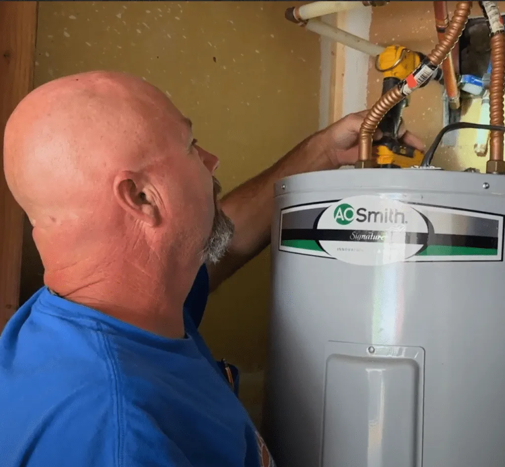 Yarbrough & Sons' plumbing team assesses an outdated water heater.