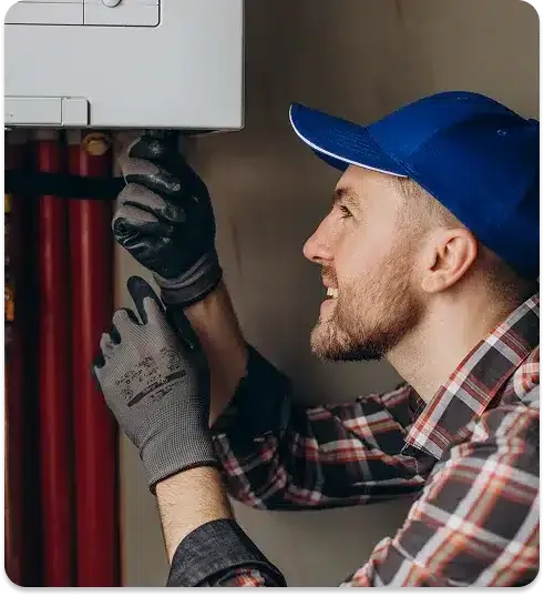 A man in a blue cap fixing a lamp with gloves.