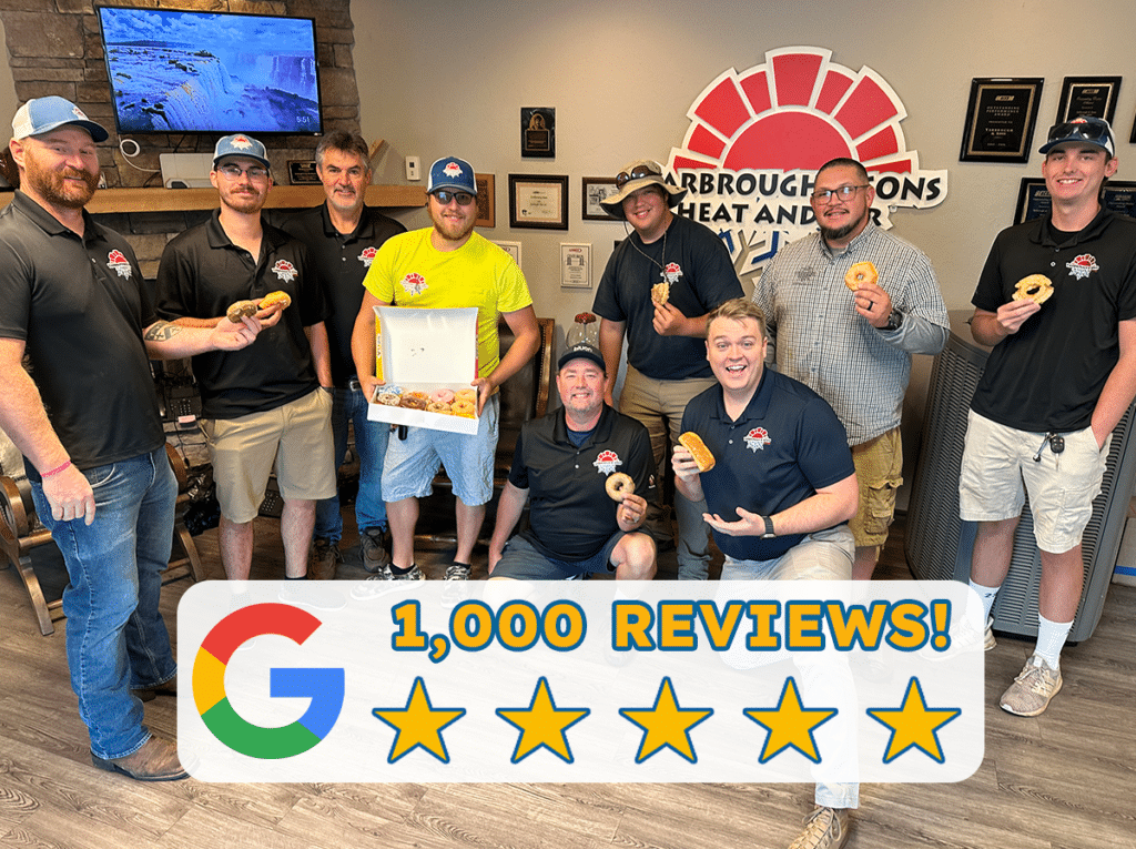 The Yarbrough & Sons Heating, Cooling & Plumbing team poses in the lobby with doughnuts to celebrate 1,000 Google reviews in July 2024.