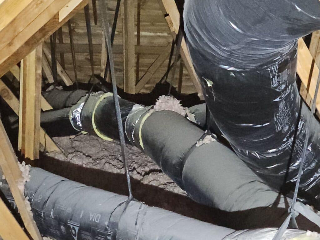 Insulated ductwork in the attic of a home during a fall maintenance visit in SW OKC.