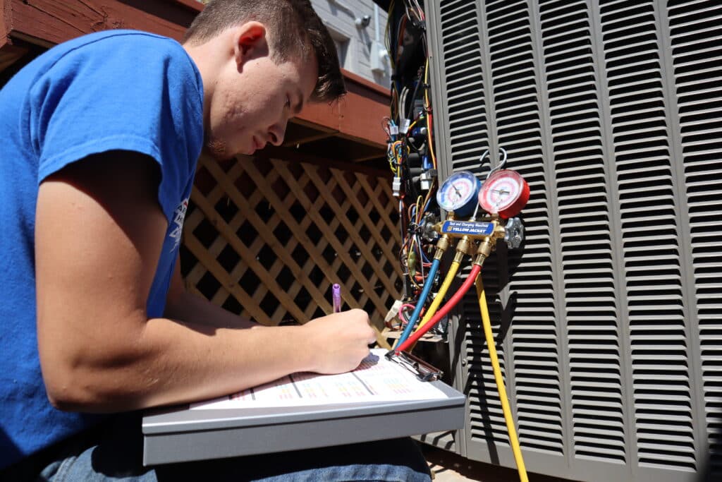 A Yarbrough & Sons technician diagnoses a residential HVAC system.