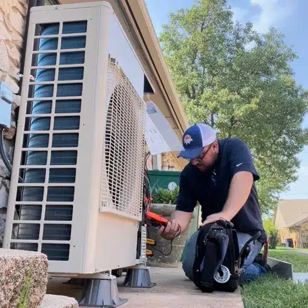 HVAC technician performing heat pump maintenance in Oklahoma City