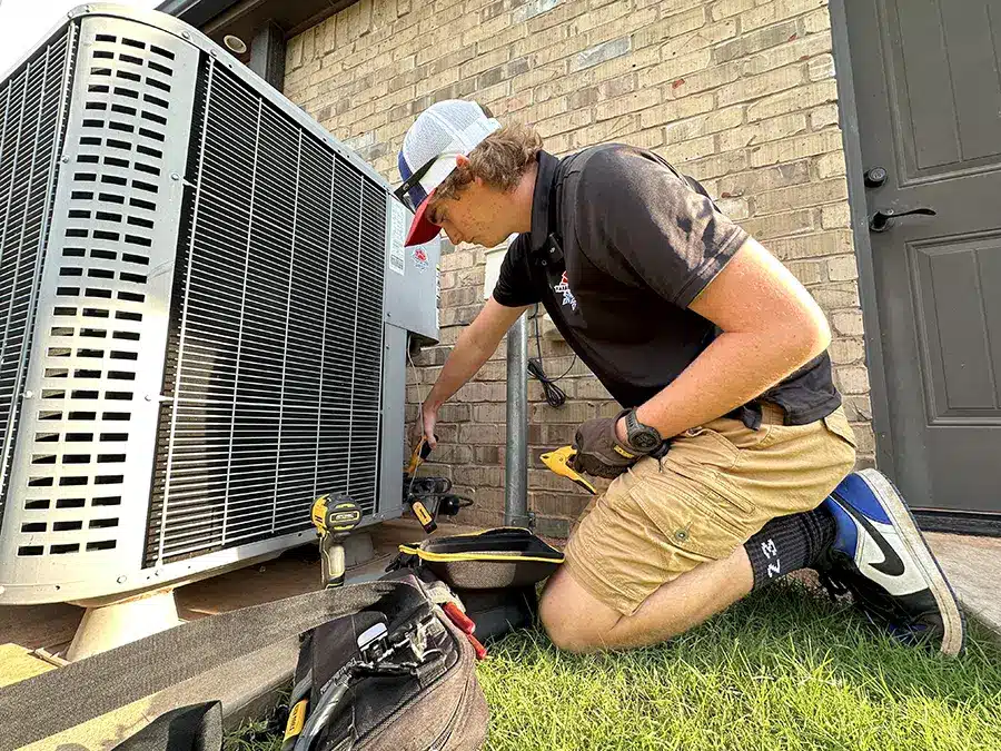 Image of HVAC technician performing ac maintenance outside of home in Oklahoma City